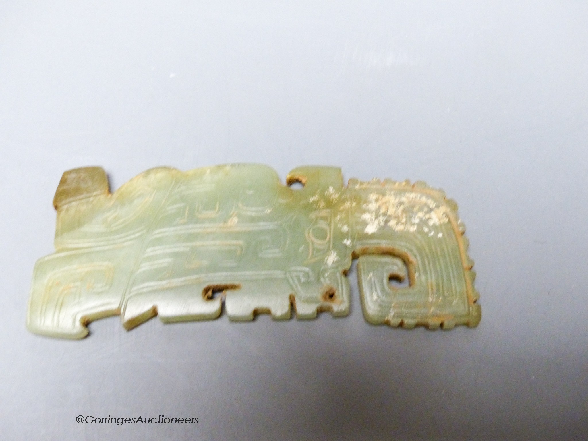 A Chinese archaistic green jade plaque, width 9cm